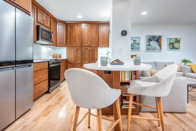 Condominium kitchen remodel in Middleton, WI with cherry cabinets, stainless appliances and a round dining table
